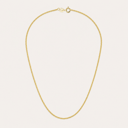 Collier Noa de OPALINE PARIS avec pendentif délicat en or et perles, porté sur un fond neutre.